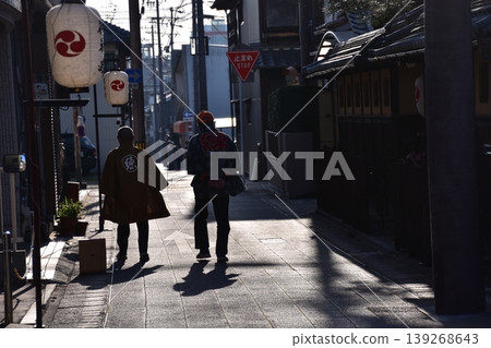 Inuyama City, Aichi Prefecture, Japan: A man wearing a happi coat walks down the street during the Inuyama Spring Festival, with lanterns displayed along the road. Inuyama City, Aichi Prefecture, Japan: A man wearing a happi coat walks down the street during the Inuyama Spring Festival, with lanterns displayed along the road. 139268643