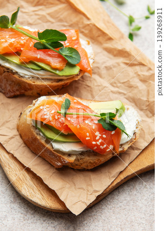 Salmon avocado toast with cream cheese and greens Salmon avocado toast with cream cheese and greens 139268911
