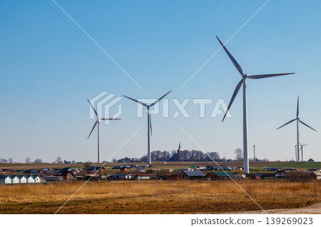 Wind turbines in a village. Renewable energy Wind turbines in a village. Renewable energy 139269023