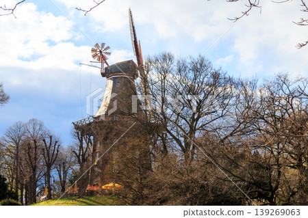 Old wooden windmill in park in Bremen, Germany Old wooden windmill in park in Bremen, Germany 139269063