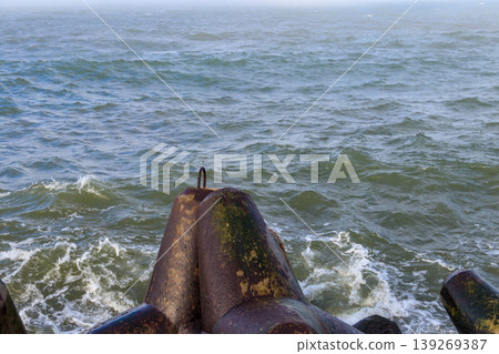 Storm in the Baltic sea. Storm waves crashing on the breakwater in Darlowo, Poland 139269387