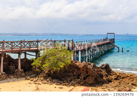 Wooden pier leading to clear blue ocean on Prison island, Zanzibar, Tanzania 139269476