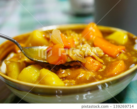 Scoop the curry with a spoon Scoop the curry with a spoon 139269714