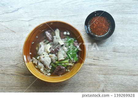 boiled pork blood and entrails with chop pork topping lettuce in soup on bowl dipping spicy sour chili sauce boiled pork blood and entrails with chop pork topping lettuce in soup on bowl dipping spicy sour chili sauce 139269928