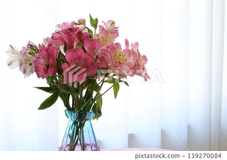 Alstroemeria arranged in a glass bottle Alstroemeria arranged in a glass bottle 139270084