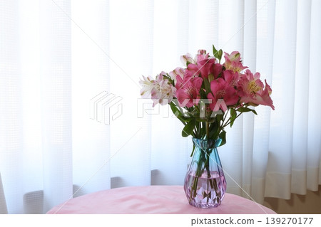 Alstroemeria arranged in a glass bottle 139270177