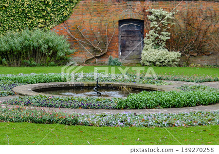 Garden fountain with flowers Oxford England United Kingdom. Garden fountain with flowers Oxford England United Kingdom. 139270258