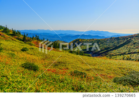 Autumn Shiga-Kusatsu Plateau Route: A spectacular view of the autumn-colored mountain slopes and vast mountain ranges from the watershed. Autumn Shiga-Kusatsu Plateau Route: A spectacular view of the autumn-colored mountain slopes and vast mountain ranges from the watershed. 139270665