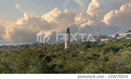 The ancient Roman lighthouse of Patara archaeological site rising above dense green forest in Lycia, Antalya, Turkey The ancient Roman lighthouse of Patara archaeological site rising above dense green forest in Lycia, Antalya, Turkey 139270834