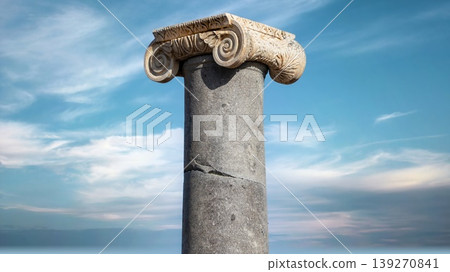 Ancient Ionic column with an ornately carved marble capital featuring twin volutes at Patara archaeological site in Turkey Ancient Ionic column with an ornately carved marble capital featuring twin volutes at Patara archaeological site in Turkey 139270841