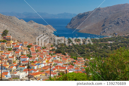Symi village and bay panorama with hillside houses in Greece on sunny day Symi village and bay panorama with hillside houses in Greece on sunny day 139270889