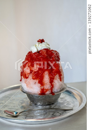 A summer dessert: shaved ice topped with strawberry syrup A summer dessert: shaved ice topped with strawberry syrup 139271062