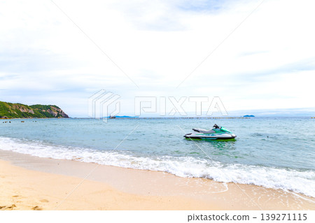 A beach with jet skis floating on it 139271115