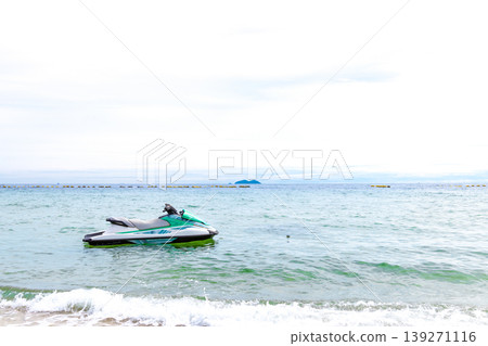 A beach with jet skis floating on it 139271116