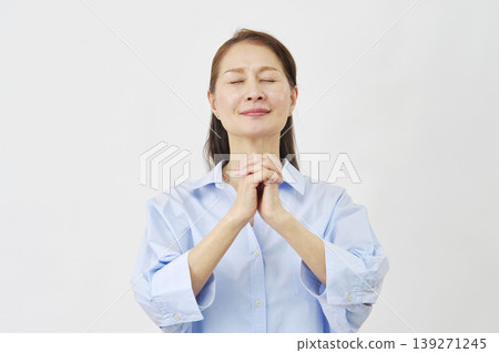 Elderly woman praying on white background 139271245