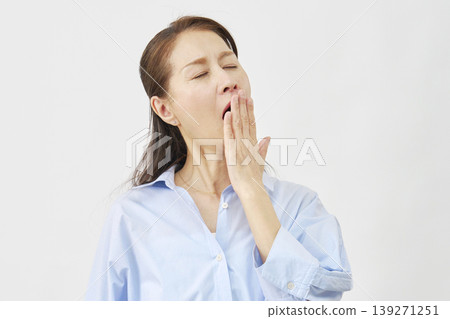 Elderly woman yawning on white background Elderly woman yawning on white background 139271251