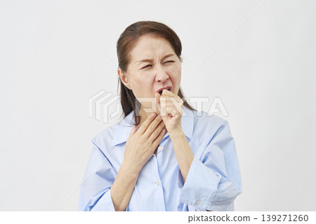 A woman coughing on a white background A woman coughing on a white background 139271260