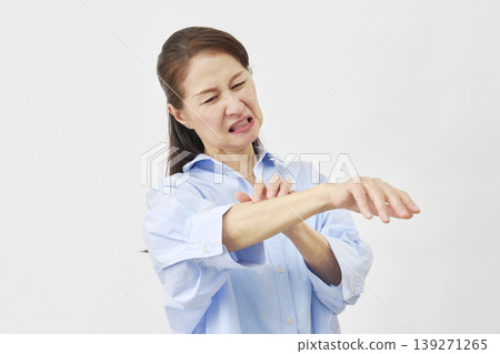 A woman scratching her arm on a white background A woman scratching her arm on a white background 139271265