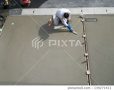A scene from a plasterer's job, painting a parking lot. A scene from a plasterer's job, painting a parking lot. 139271411
