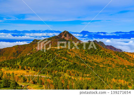 A spectacular view from Yokoteyama Drive-in: The Northern Alps floating in a sea of clouds and the mountain slopes painted in autumn colors. A spectacular view from Yokoteyama Drive-in: The Northern Alps floating in a sea of clouds and the mountain slopes painted in autumn colors. 139271654