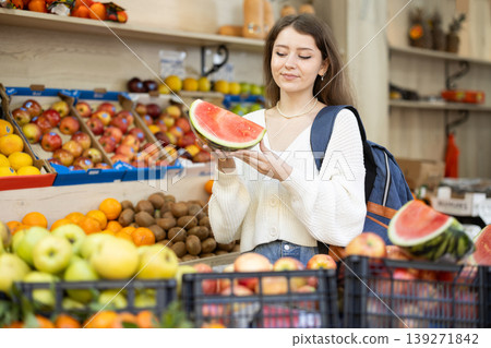 woman with a backpack went to a supermarket for fruit woman with a backpack went to a supermarket for fruit 139271842
