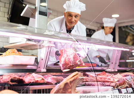 Professional butcher showing piece of fresh raw veal tenderloin Professional butcher showing piece of fresh raw veal tenderloin 139272014