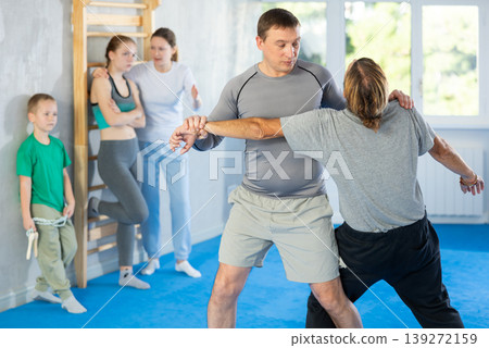 Man in gym perform basic elements of krav maga self-defense system. 139272159