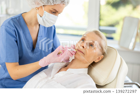 Woman applying rejuvenating treatments by doctor. 139272297