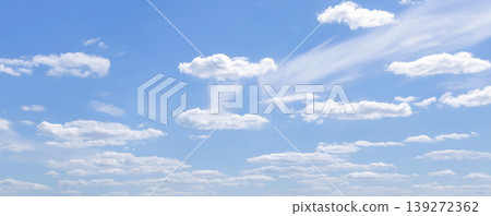 Clear blue sky filled with soft white clouds on a sunny day. Minimal cloudscape background for weather, calm nature, seasonal design and airy outdoor atmosphere. Clear blue sky filled with soft white clouds on a sunny day. Minimal cloudscape background for weather, calm nature, seasonal design and airy outdoor atmosphere. 139272362