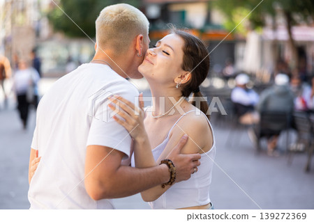 guy and a girl kiss on the cheek when they meet guy and a girl kiss on the cheek when they meet 139272369