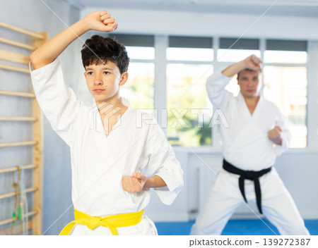 Man and boy teenager train karate technique Man and boy teenager train karate technique 139272387