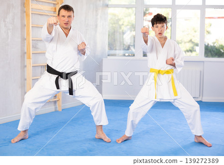 Man and boy teenager train karate technique Man and boy teenager train karate technique 139272389