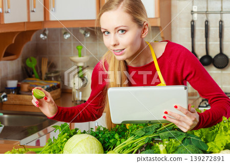 Woman having green vegetables thinking about cooking Woman having green vegetables thinking about cooking 139272891