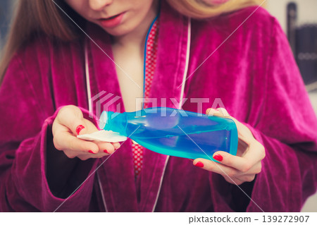 Woman applying tonic on cotton pad 139272907
