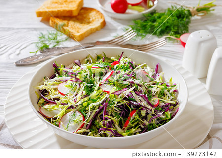 Fresh cabbage and radish coleslaw in white bowl Fresh cabbage and radish coleslaw in white bowl 139273142