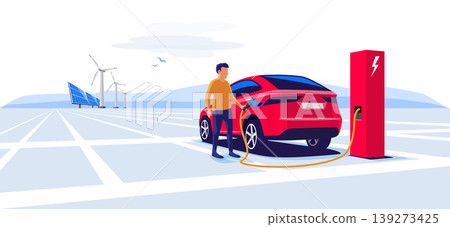 Man Standing and Charging an Electric Car Suv Man Standing and Charging an Electric Car Suv 139273425