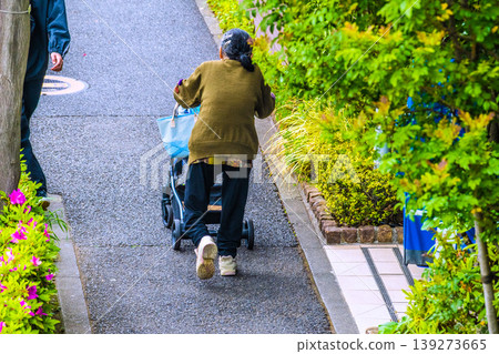 Uneven terrain in Yokohama, Japan…an elderly woman (wearing a mask) on a four-wheeled cart…shaking violently…=Yokohama city Uneven terrain in Yokohama, Japan…an elderly woman (wearing a mask) on a four-wheeled cart…shaking violently…=Yokohama city 139273665