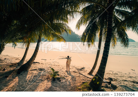Golden hour morning light over a tranquil tropical bay with calm water and pristine shores. 139273704