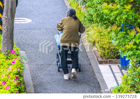 Uneven terrain in Yokohama, Japan…an elderly woman (wearing a mask) on a four-wheeled cart…shaking violently…=Yokohama city Uneven terrain in Yokohama, Japan…an elderly woman (wearing a mask) on a four-wheeled cart…shaking violently…=Yokohama city 139273728