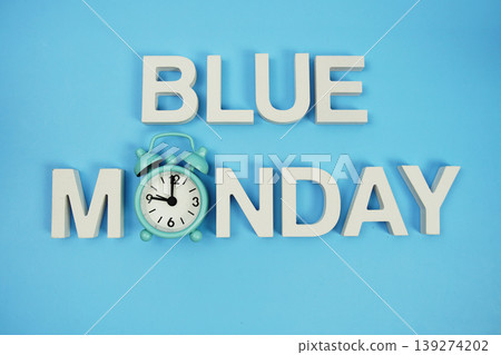 Blue Monday alphabet letters with alarm clock on blue background Blue Monday alphabet letters with alarm clock on blue background 139274202