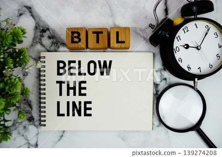 BTL Below The Line text with alarm clock and magnifying glass on marble background 139274208