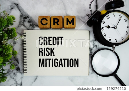 CRM Credit Risk Mitigation text with calculator and alarm clock on marble background CRM Credit Risk Mitigation text with calculator and alarm clock on marble background 139274210