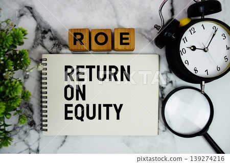 ROE Return on Equity text with alarm clock and magnifying glass on marble background ROE Return on Equity text with alarm clock and magnifying glass on marble background 139274216