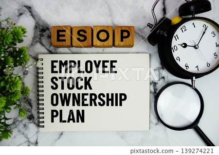 ESOP Employee Stock Ownership Program text with alarm clock and magnifying glass on marble background ESOP Employee Stock Ownership Program text with alarm clock and magnifying glass on marble background 139274221