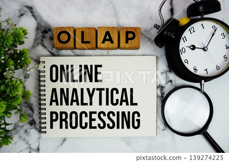 OLAP Online Analytical Processing text with alarm clock and magnifying glass on marble background OLAP Online Analytical Processing text with alarm clock and magnifying glass on marble background 139274225
