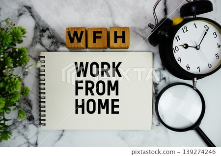 WFH Work From Home text with alarm clock and magnifying glass on marble background WFH Work From Home text with alarm clock and magnifying glass on marble background 139274246