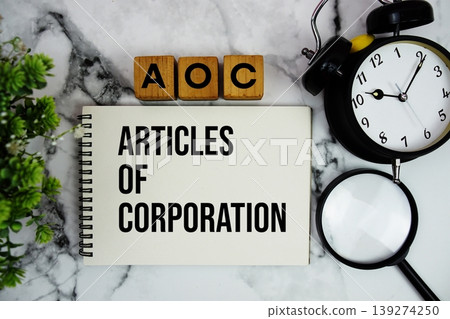 AOC Articles of Corporation text with alarm clock and magnifying glass on marble background AOC Articles of Corporation text with alarm clock and magnifying glass on marble background 139274250