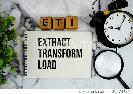 ETL Extract Transform Load text with alarm clock and magnifying glass on marble background 139274255