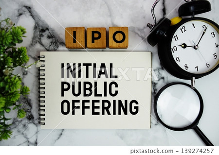 IPO Initial Public Offering text with alarm clock and magnifying glass on marble background 139274257