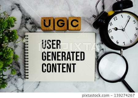 UGC User Generated Content text with alarm clock and magnifying glass on marble background UGC User Generated Content text with alarm clock and magnifying glass on marble background 139274267